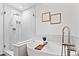 Bathroom boasts a modern tub with a stylish faucet, glass-enclosed shower, and contemporary fixtures at 152 S Jackson St, Denver, CO 80209