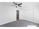 Spacious bedroom featuring a ceiling fan, large closet, and an open doorway at 152 S Jackson St, Denver, CO 80209