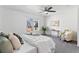 Bright bedroom features a ceiling fan, a cozy chair and view of the outdoors from the large window at 152 S Jackson St, Denver, CO 80209