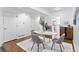 Bright dining room featuring modern decor, a marble dining table, and nearby kitchen entrance at 152 S Jackson St, Denver, CO 80209
