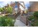 Charming townhome with brick facade, well-manicured landscaping, and a welcoming stairway at 152 S Jackson St, Denver, CO 80209