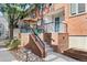 Brick front porch with a patio set, umbrella, and wrought-iron railing at 152 S Jackson St, Denver, CO 80209