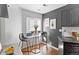 Bright kitchen nook featuring a bistro table set, modern window blinds, and stylish grey accent wall at 152 S Jackson St, Denver, CO 80209