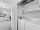 Laundry closet with a white washer and dryer and a view of a bedroom in the background at 152 S Jackson St, Denver, CO 80209