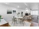 Bright living space featuring modern decor, a marble dining table, a fireplace, and neutral furniture at 152 S Jackson St, Denver, CO 80209