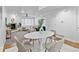 Bright, open-concept living space features modern furniture, a marble dining table, and a fireplace at 152 S Jackson St, Denver, CO 80209
