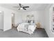 Comfortable main bedroom with ceiling fan, natural light, and a view of the ensuite bathroom at 152 S Jackson St, Denver, CO 80209