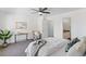 Comfortable main bedroom with a ceiling fan and an attached bath, walk-in closet, and console table at 152 S Jackson St, Denver, CO 80209