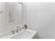 Modern powder room featuring a stylish sink, brushed nickel faucet, and neutral wall color at 152 S Jackson St, Denver, CO 80209