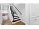 Modern staircase features black metal railings and hardwood flooring at 152 S Jackson St, Denver, CO 80209