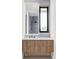 Modern bathroom features a light-up mirror and light wood cabinetry with dark hardware at 545 Strada Rossa Rd, Golden, CO 80401