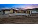 Contemporary home featuring a stone facade, multiple garage doors, and concrete driveway at dusk at 545 Strada Rossa Rd, Golden, CO 80401