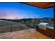 Outdoor patio with concrete flooring, wood ceiling, built-in grill, and scenic views at 545 Strada Rossa Rd, Golden, CO 80401