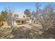 The fenced-in backyard features a patio, gravel, and grassy areas at 1348 E Jamison Ave, Centennial, CO 80122