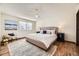 This spacious bedroom has a large window, ceiling fan, and hardwood floors at 1348 E Jamison Ave, Centennial, CO 80122