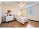 Bright bedroom featuring a single bed, dresser, window and hardwood floors at 1348 E Jamison Ave, Centennial, CO 80122