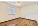 This bedroom is naturally lit, featuring hardwood floors and blinds at 1348 E Jamison Ave, Centennial, CO 80122