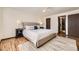 This bedroom features hardwood floors, ceiling fan, and entry to bathroom at 1348 E Jamison Ave, Centennial, CO 80122