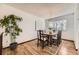 Cozy dining room featuring hardwood floors, a chandelier, and large windows at 1348 E Jamison Ave, Centennial, CO 80122