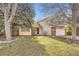 Charming two-story home with brick accents, a blue front door, and an attached garage at 1348 E Jamison Ave, Centennial, CO 80122