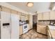 Bright kitchen featuring tiled countertops and floors with white appliances at 1348 E Jamison Ave, Centennial, CO 80122