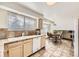 Kitchen with tiled countertops, flows into a dining area with scenic views at 1348 E Jamison Ave, Centennial, CO 80122
