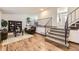 Open living room with hardwood floors, fireplace, and staircase to the upper level at 1348 E Jamison Ave, Centennial, CO 80122