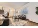 Bright living room with hardwood floors, large windows, and comfortable seating arrangement at 1348 E Jamison Ave, Centennial, CO 80122