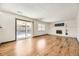 Open living area with wood floors, fireplace, and access to an outdoor patio at 1348 E Jamison Ave, Centennial, CO 80122