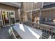 The back patio features an umbrella, an outdoor dining table and chairs, and a view of the home's exterior at 13778 Umatilla Ln, Broomfield, CO 80023