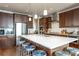 The kitchen island offers seating and plenty of counter space with stainless steel appliances and a modern aesthetic at 13778 Umatilla Ln, Broomfield, CO 80023