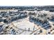 An aerial view shows the neighborhood in winter with sidewalks and well-maintained homes at 23527 E 5Th Pl, Aurora, CO 80018