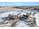 An aerial view shows a clubhouse, pool and other neighborhood amenities in a snowy landscape at 23527 E 5Th Pl, Aurora, CO 80018