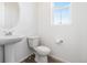 This powder room features a pedestal sink and wood-look flooring at 23527 E 5Th Pl, Aurora, CO 80018