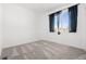 A simple bedroom has a large window and neutral carpet at 23527 E 5Th Pl, Aurora, CO 80018