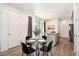 Dining area featuring stylish seating, ample lighting, and convenient kitchen access at 23527 E 5Th Pl, Aurora, CO 80018