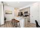 Modern kitchen with stainless steel appliances, island, and bar stool seating at 23527 E 5Th Pl, Aurora, CO 80018