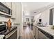 Modern kitchen featuring stainless steel appliances, granite countertops, and an open layout at 23527 E 5Th Pl, Aurora, CO 80018