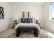 A bright bedroom boasts a large patterned rug and neutral decor at 23527 E 5Th Pl, Aurora, CO 80018