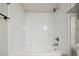 Clean bathroom with tiled walls and a bathtub-shower combination at 8775 W Berry Ave # 203, Littleton, CO 80123