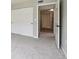 Carpeted bedroom features an open door and large closet at 8775 W Berry Ave # 203, Littleton, CO 80123