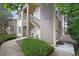 Attractive two-story condo featuring well-manicured landscaping, inviting entryway, and visible unit number at 8775 W Berry Ave # 203, Littleton, CO 80123