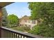 Scenic view from balcony overlooking lush landscaping, mature trees, and charming neighborhood architecture at 8775 W Berry Ave # 203, Littleton, CO 80123