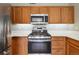 Well-equipped kitchen featuring stainless steel appliances, ample counter space, and stylish cabinetry at 8775 W Berry Ave # 203, Littleton, CO 80123