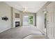 Bright, spacious living room with a fireplace, ceiling fan, and sliding glass doors to the balcony at 8775 W Berry Ave # 203, Littleton, CO 80123