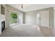 Open-concept living area with a fireplace and sliding glass doors that lead to a private balcony at 8775 W Berry Ave # 203, Littleton, CO 80123