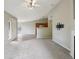 Cozy living area with a fireplace, modern lighting, and an open view into the kitchen at 8775 W Berry Ave # 203, Littleton, CO 80123