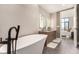 Modern bathroom featuring a soaking tub, dual sinks, and access to the main bedroom at 1901 Wazee St # 807, Denver, CO 80202