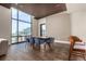 Modern dining area with hardwood floors, large windows, and stylish blue chairs at 1901 Wazee St # 807, Denver, CO 80202