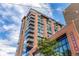 Tall red brick building, known as 'The Rally', featuring multiple balconies at 1901 Wazee St # 807, Denver, CO 80202